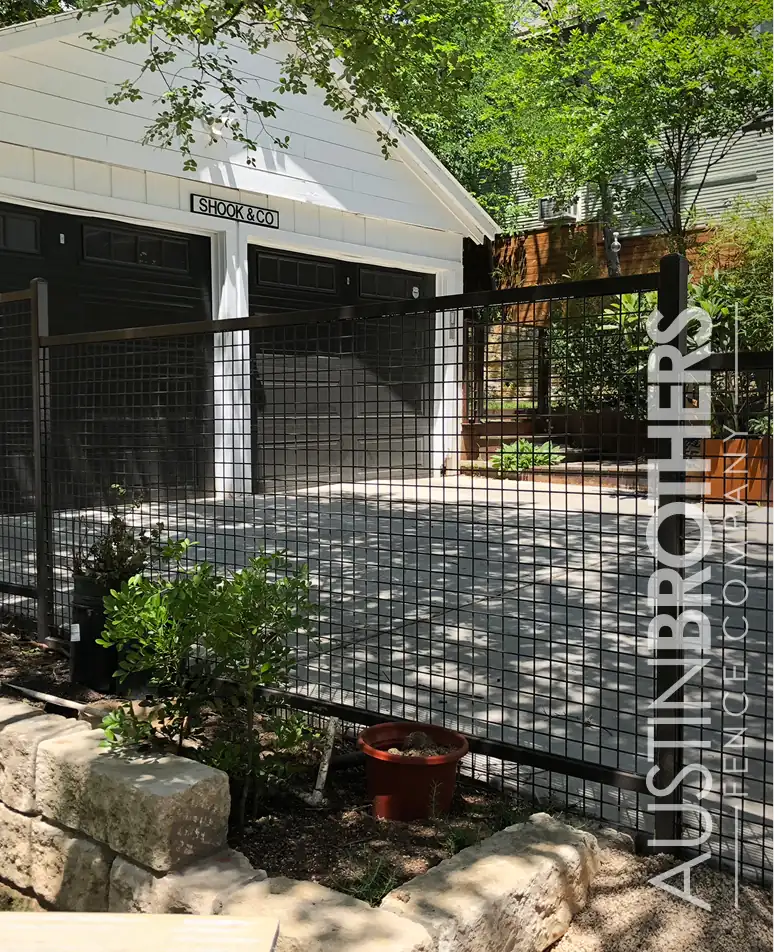 Black steel bull panel fence along a landscaped front yard