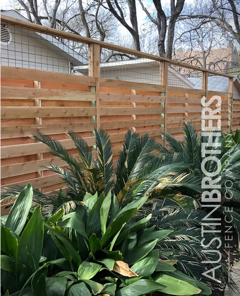 Horizontal cedar fence behind agave and desert landscaping
