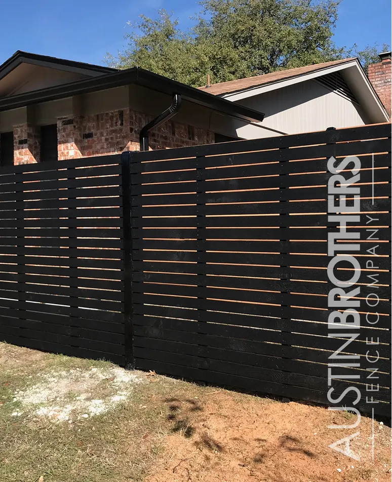 Black horizontal slat fence built by Austin Brothers Fence Company